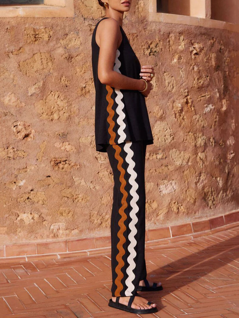 Conjunto de dos piezas con top holgado sin mangas y abertura, y pantalones de pierna ancha