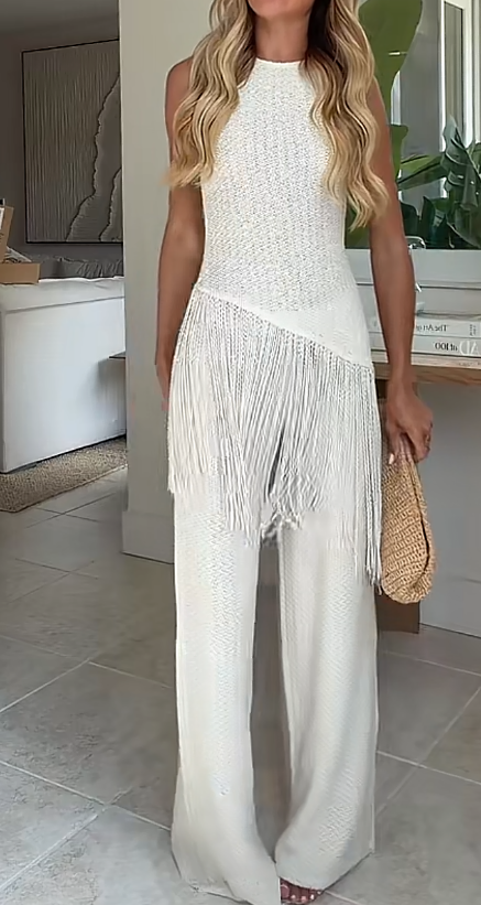Completo chic bianco con top all'uncinetto senza maniche e nappine, e pantaloni a gamba larga