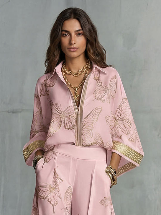 Set elegante con top con zip e stampa a farfalle e pantaloni a gamba larga