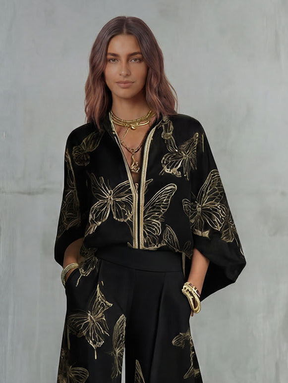 Set elegante con top con zip e stampa a farfalle e pantaloni a gamba larga