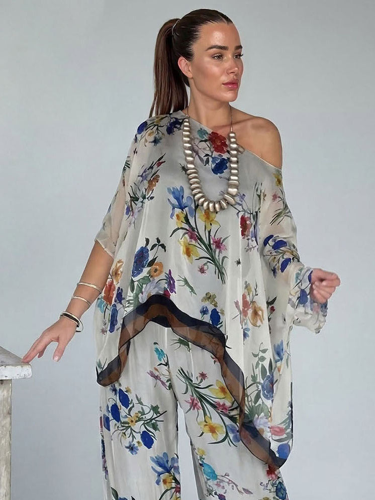 Conjunto elegante de top assimétrico de um ombro, em chiffon transparente com estampado floral, e calças de perna larga