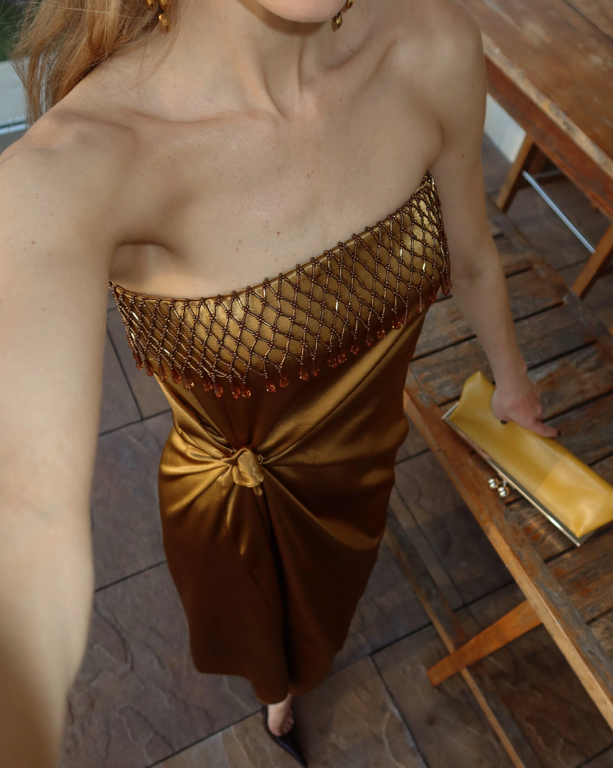 Strapless Metallic Gold Satin Maxi Dress with Fringe Neckline and Knot Draping [erp-image:cd297d1a9d203068ec2e0d41]